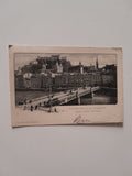 AK Salzburg mit der Stadtbrücke gegen Hohen Salzburg.