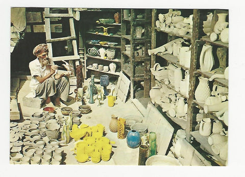 AK Peshawar, West Pakistan. An old Potter Colouring his pottery.